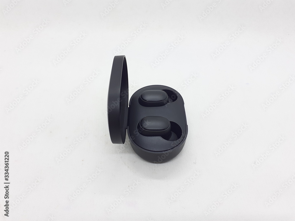 Black Electronic Modern Elegant Wireless Ear Pieces for Listening Music and Phone Tools in White Isolated Background Black Electronic Modern Elegant Wireless Ear Pieces for Listening Music and Phone Tools in White Isolated Background