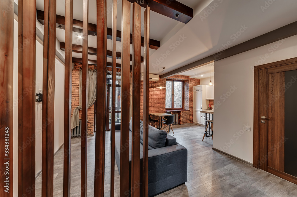 Fototapeta premium Interior of a modern loft style apartment. Living room and kitchen