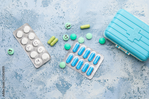 Pills with drawn faces on c...