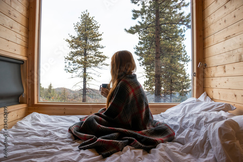 Woman with Cozy Blanket and Cup of Tea