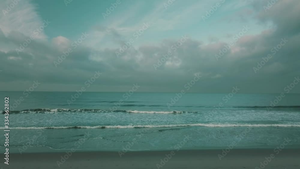 Drone Flys upward revealing beautiful beach and ocean view Drone Flys upward revealing beautiful beach and ocean view