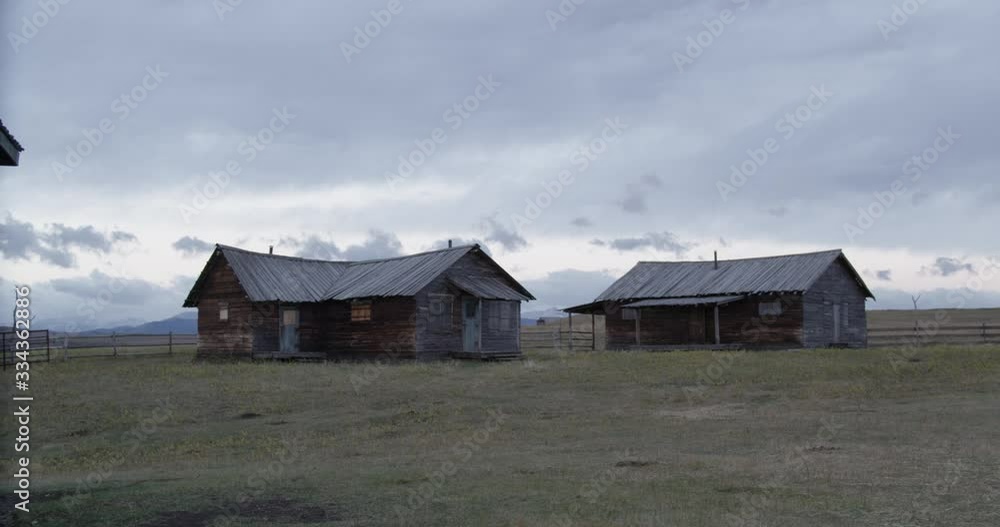 Two bygone Houses resting on a Prairie Field Two bygone Houses resting on a Prairie Field