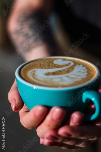 Cup of cappuccino coffee with beautiful latte art