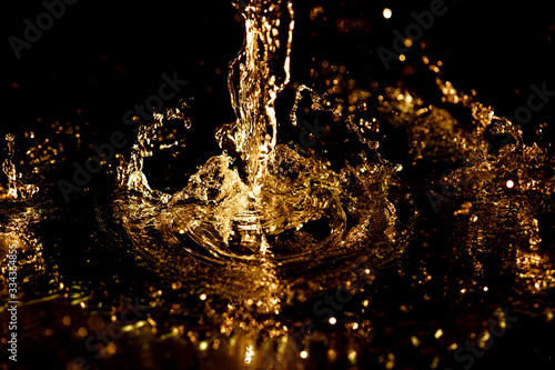 Splashes and drops of water on a black background.