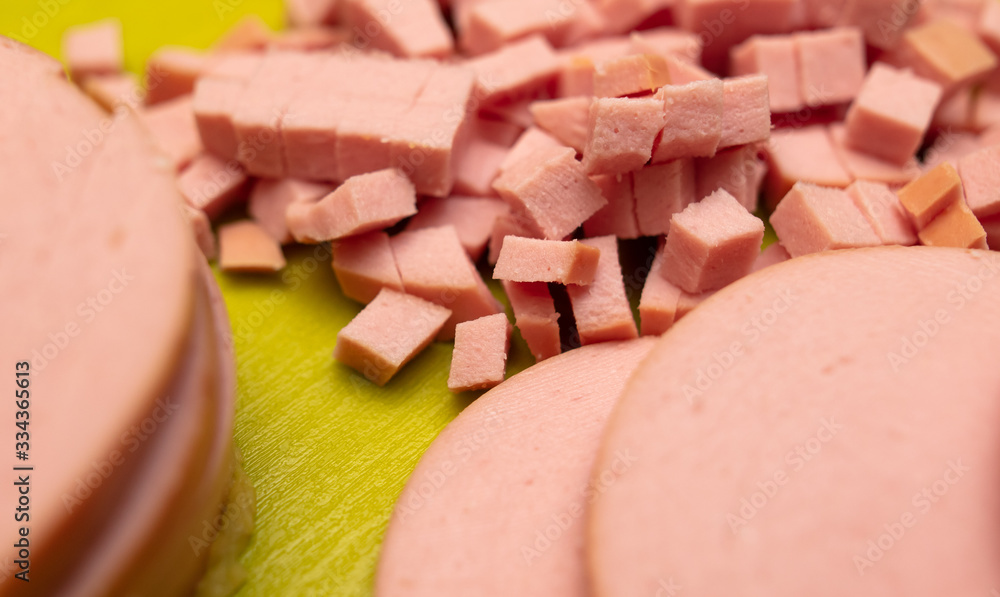 Sliced sausage on a plastic board. Sliced sausage on a plastic board.