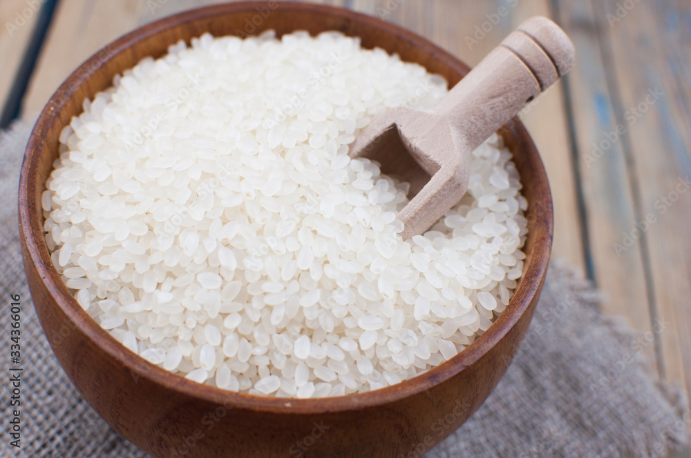 Rice bowl and spoon are placed on old wooden floor. Rice bowl and spoon are placed on old wooden floor.