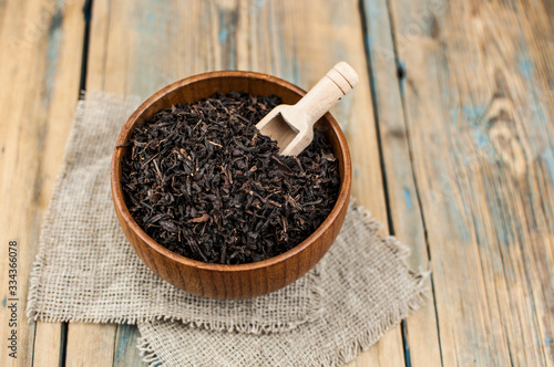 close-up of dry chinese tea in woonden bowl photo