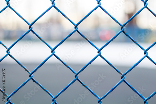 Fence on the sky, blue mesh fence, chain link fence Soft focus.