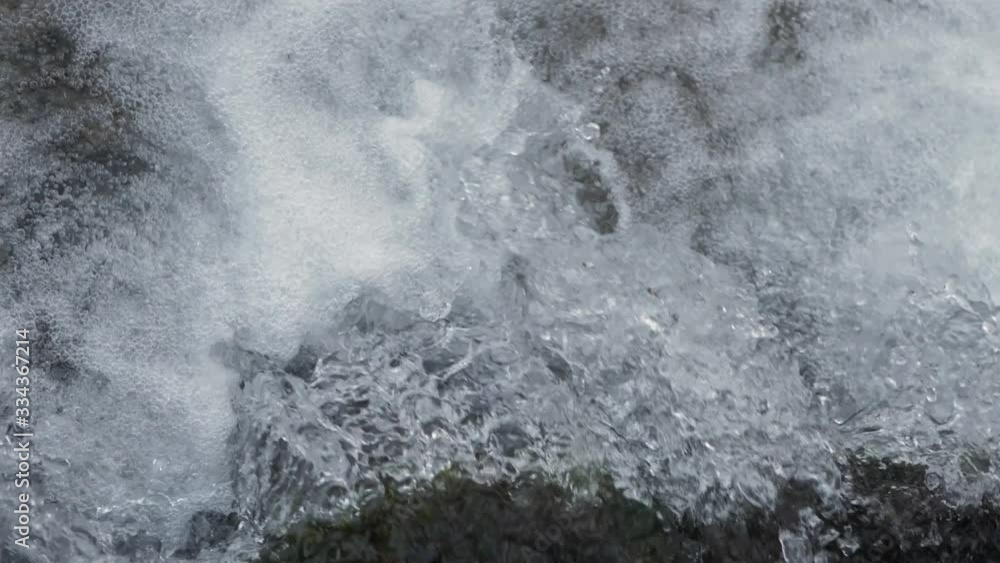 Close-up waterfall, water falling and bubbling slow motion Close-up waterfall, water falling and bubbling slow motion