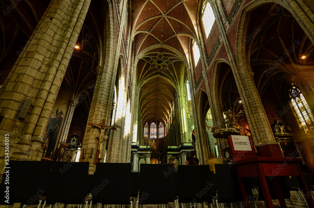 Ghent, Belgium, August 2019. Interior view of the Cathedral of San Bavo. We are impressed by the height and the slender lines of the pointed arch vaults. Red bricks.