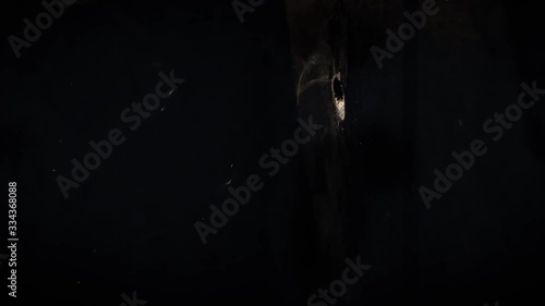 Texture of a shot into a wall, bulletproof vest from a firearm, through penetration of an obstacle by an incendiary projectile, the bullet breaks through the barrier in slow motion photo