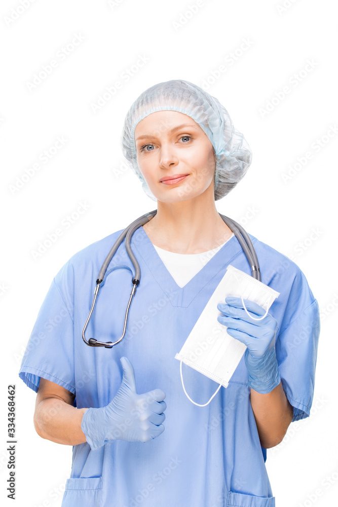 Young dentist, surgeon or other professional pointing at protective mask Young dentist, surgeon or other professional pointing at protective mask