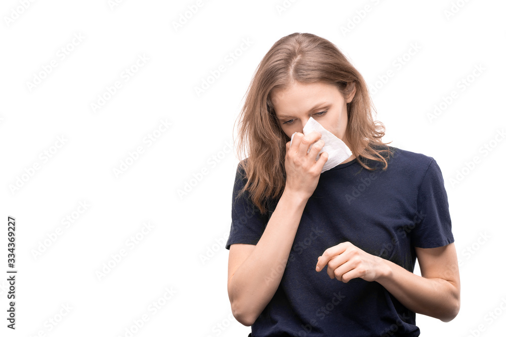Sick young woman with rhinitis holding handkerchief by blowing nose Sick young woman with rhinitis holding handkerchief by blowing nose