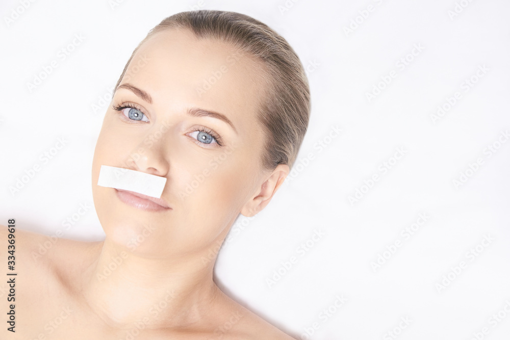 Girl wax lip at depilation center. Professional remove unwante hair on woman face. Natural wax epilation service. Beauty waxing salon. Girl wax lip at depilation center. Professional remove unwante hair on woman face. Natural wax epilation service. Beauty waxing salon.