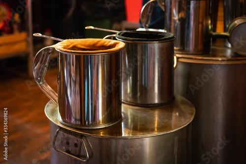 Making Thai coffee and tea using coffee bag in ancient stainless steel pot.