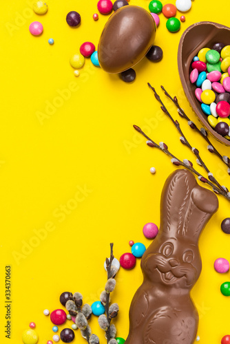 Easter Background. Chocolate Rabbit and Eggs with Colorful Candy. Copy Space on Flat Lay Design