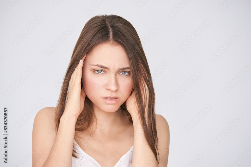 Young pretty girl with migraine. Headache woman pain. Stress sick model portrait. Negative emotion portrait. Sad people. Young pretty girl with migraine. Headache woman pain. Stress sick model portrait. Negative emotion portrait. Sad people.
