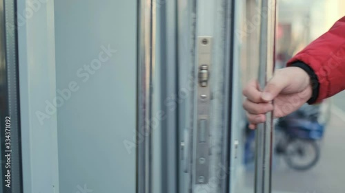 Man hand opening office door handle close up. Entering to the store. Hygiene virus protection concept 4k
