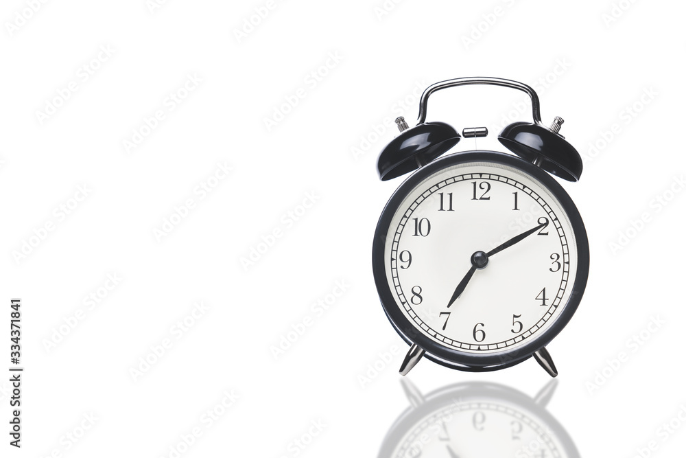 black alarm clock on white with reflection, space for text on the right black alarm clock on white with reflection, space for text on the right