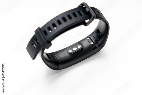 black fitness tracker on a white background, selective focus