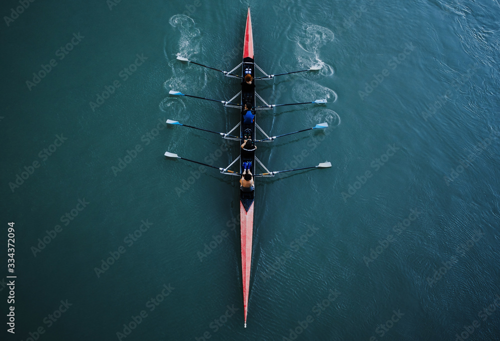 Kayak from above with 4 rowing people. Blue and aqua water background. Sport and moving concept. Red kayak and 8 paddles. - obrazy, fototapety, plakaty 