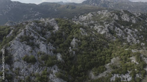 Aerial footage of rocky mountains, mountain range in Montenegro. Countryside. Forest. Grahovo village, Rural landscape.