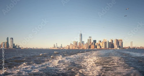 Hyperlapse from the deck of staten island ferry. Downtown Manhattan skyline and statue of liberty seen from the sea.