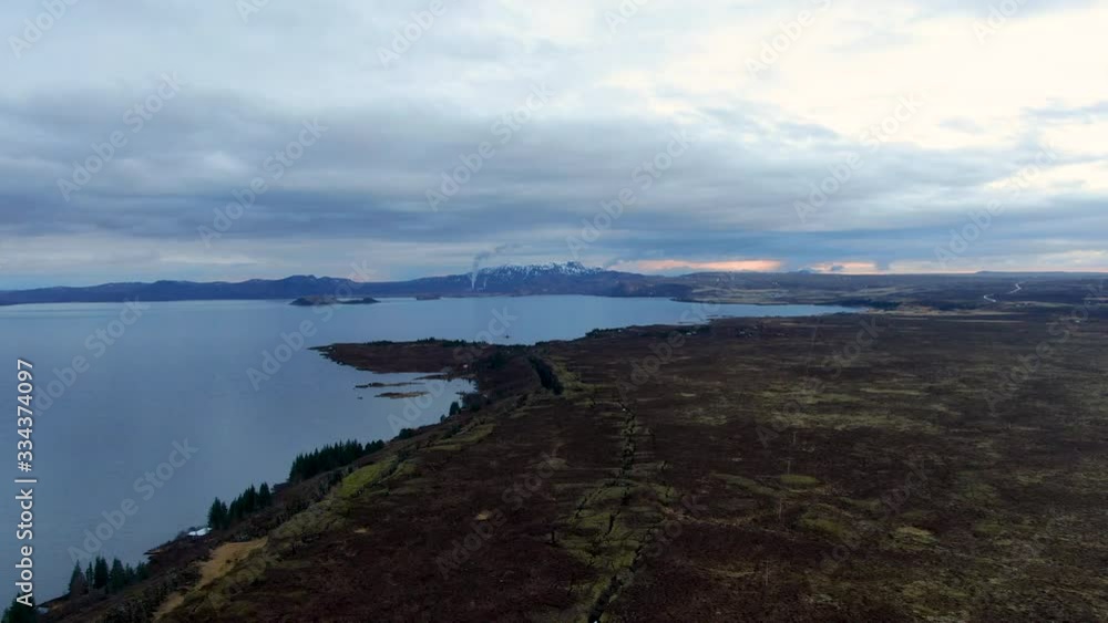 green and blue Icelandic landscape with view on the lake and white clouds during sunset green and blue Icelandic landscape with view on the lake and white clouds during sunset