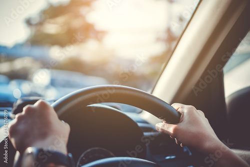 Wallpaper Mural Hand of woman on steering wheel drive a car background. Torontodigital.ca