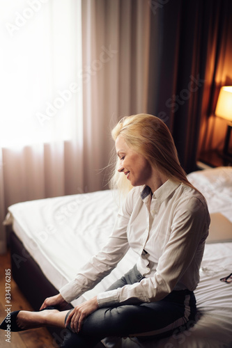 Businesswoman relaxing after meetings.Young beautiful woman working from a hotel room.	