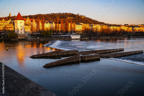 Prague city on Vltava river with Janackovo embankment at sunrise. photo