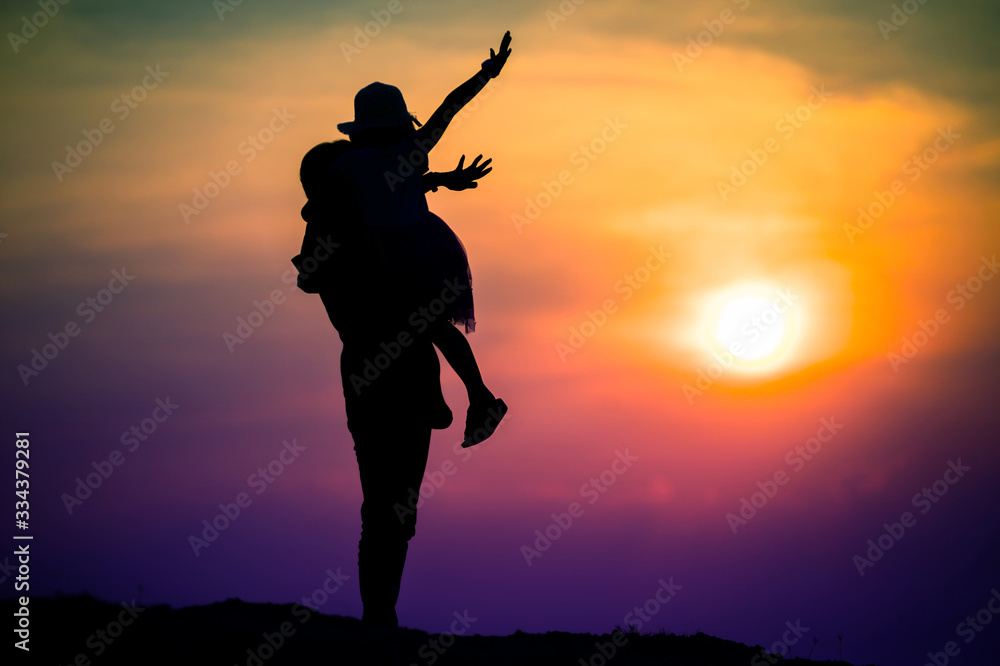 silhouette of a family with a happy mother playing with a girl in the sunset sky silhouette of a family with a happy mother playing with a girl in the sunset sky