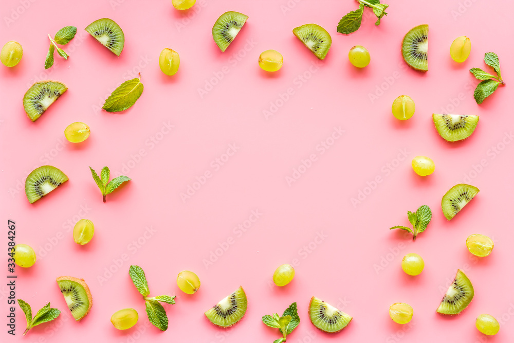 Slices fruites frame. Fruit salad concept with citruses, aplle and kiwi on pink background top-down copy space Slices fruites frame. Fruit salad concept with citruses, aplle and kiwi on pink background top-down copy space
