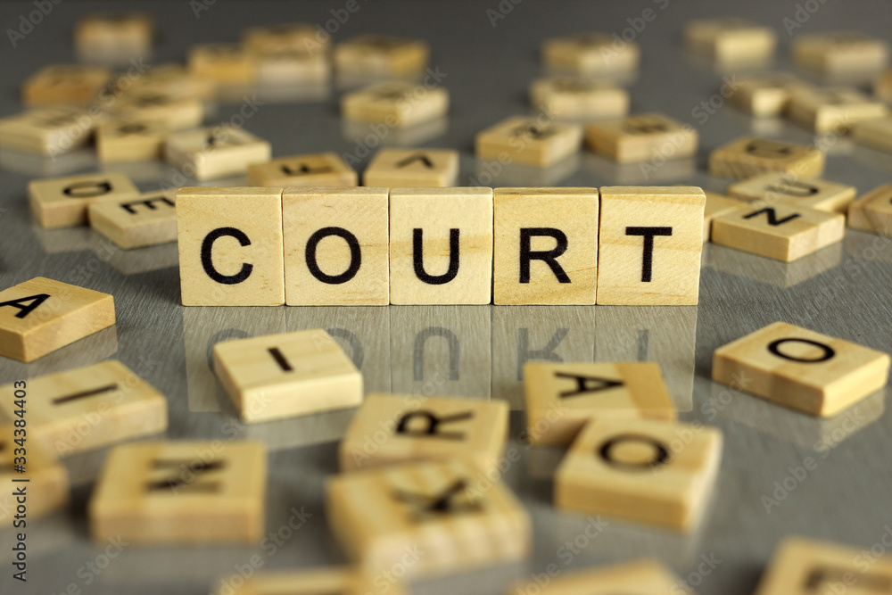 word court made of square wooden letters on a gray background word court made of square wooden letters on a gray background