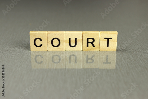 word court made of square wooden letters on a gray background