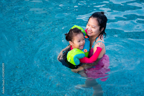Asia Child Girl Swimming with Mother 