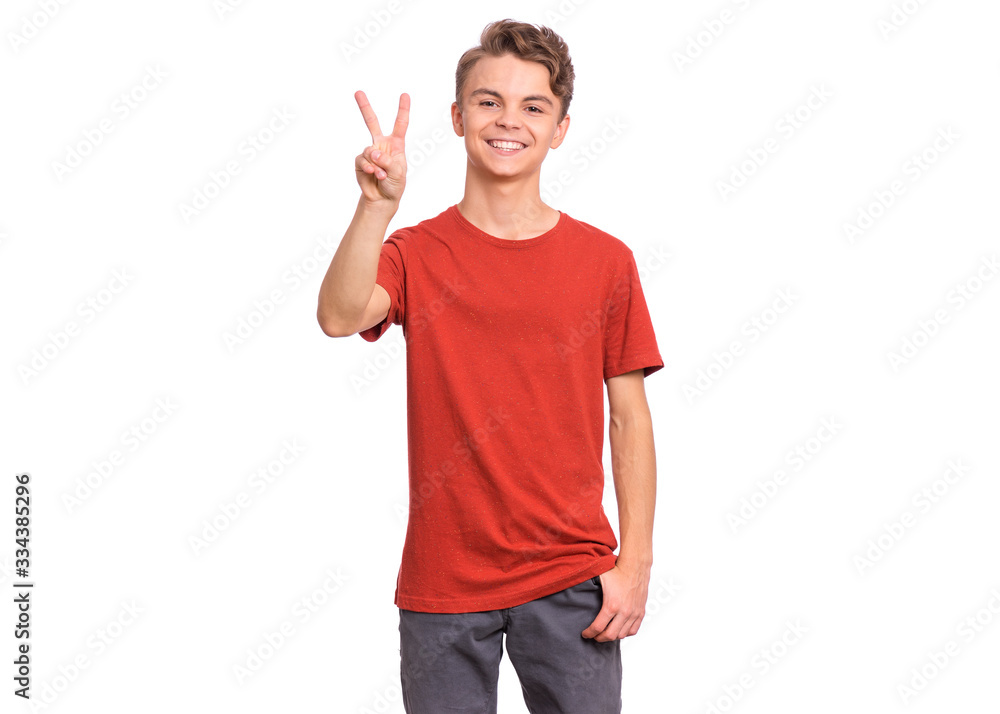 Portrait of teen boy making Victory gesture, isolated on white background. Handsome caucasian young teenager smiling and showing victory sign. Happy cute child doing victory symbol. Portrait of teen boy making Victory gesture, isolated on white background. Handsome caucasian young teenager smiling and showing victory sign. Happy cute child doing victory symbol.