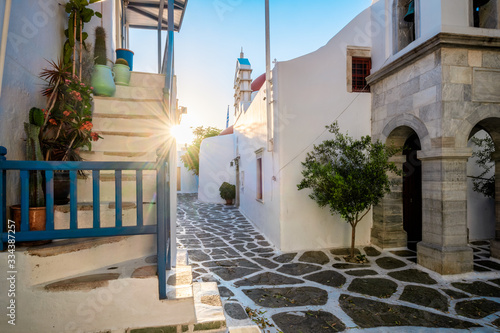 Picturesque scenic narrow streets with traditional whitewashed houses with blue doors windows of Mykonos Chora town in famous tourist attraction Mykonos island, Greece
