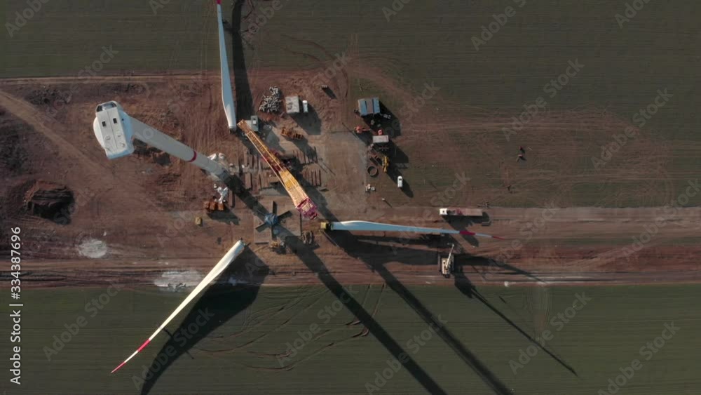 Building process of wind energy power tower mill, under construction. Transportation, installation of rotor blades. Green, clean, renewable energy. Aerial footage. Building process of wind energy power tower mill, under construction. Transportation, installation of rotor blades. Green, clean, renewable energy. Aerial footage.