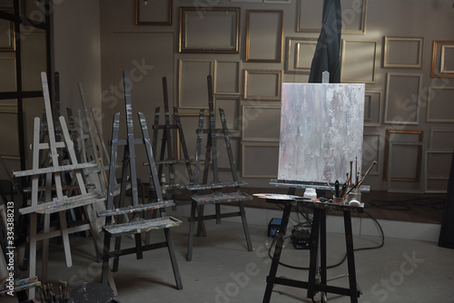Fototapeta Interior of contemporary arts school or studio with unfinished picture on easel