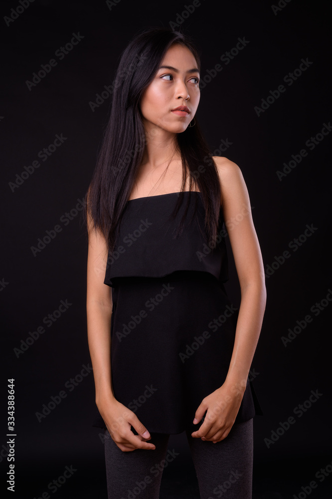 Portrait of young beautiful Asian woman looking away Portrait of young beautiful Asian woman looking away