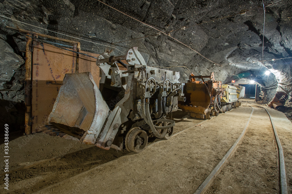 Fototapeta premium Ore loading machine eimco in underground gold mine tunnel