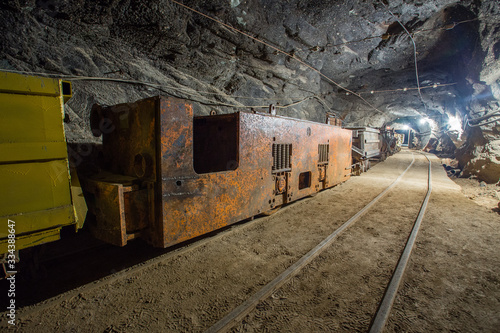Electric locomotive in underground gold mine tunnel