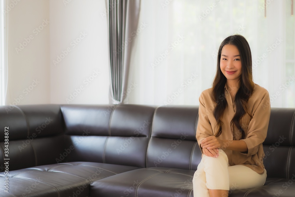 Portrait beautiful young asian woman happy smile relax on sofa in living room Portrait beautiful young asian woman happy smile relax on sofa in living room