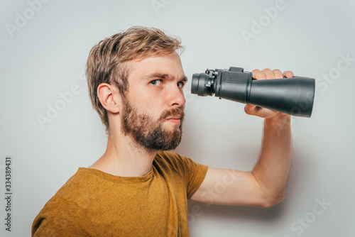 man with binoculars. gray background