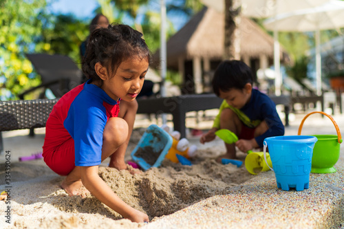 Kids playing with beach sand with they toys