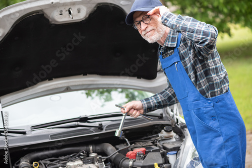 Car mechanic working on car engine