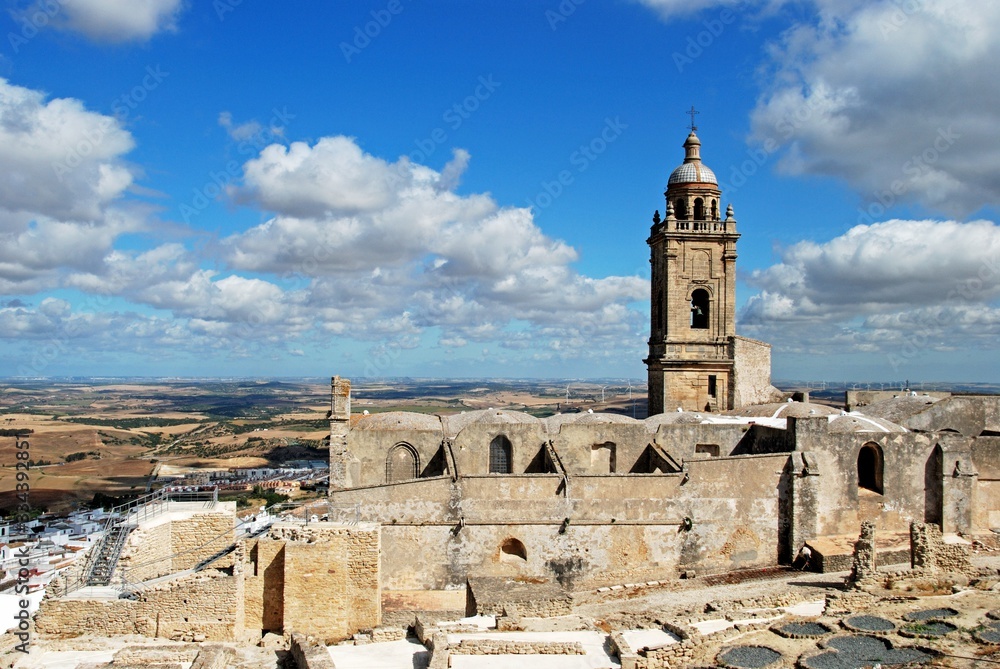 Medieval town wall and Santa Maria church bell tower, Medina Sidonia, Spain.