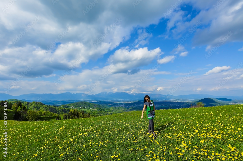 Fototapeta premium Woman in the field and blue sky clouds