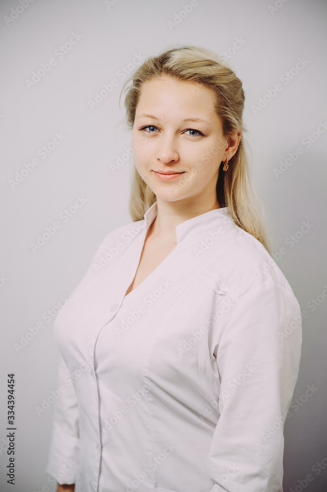 Portrait of an attractive young female doctor in white coat. Portrait of an attractive young female doctor in white coat.